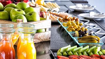 A buffet table with various fruits, vegetables, and condiments.