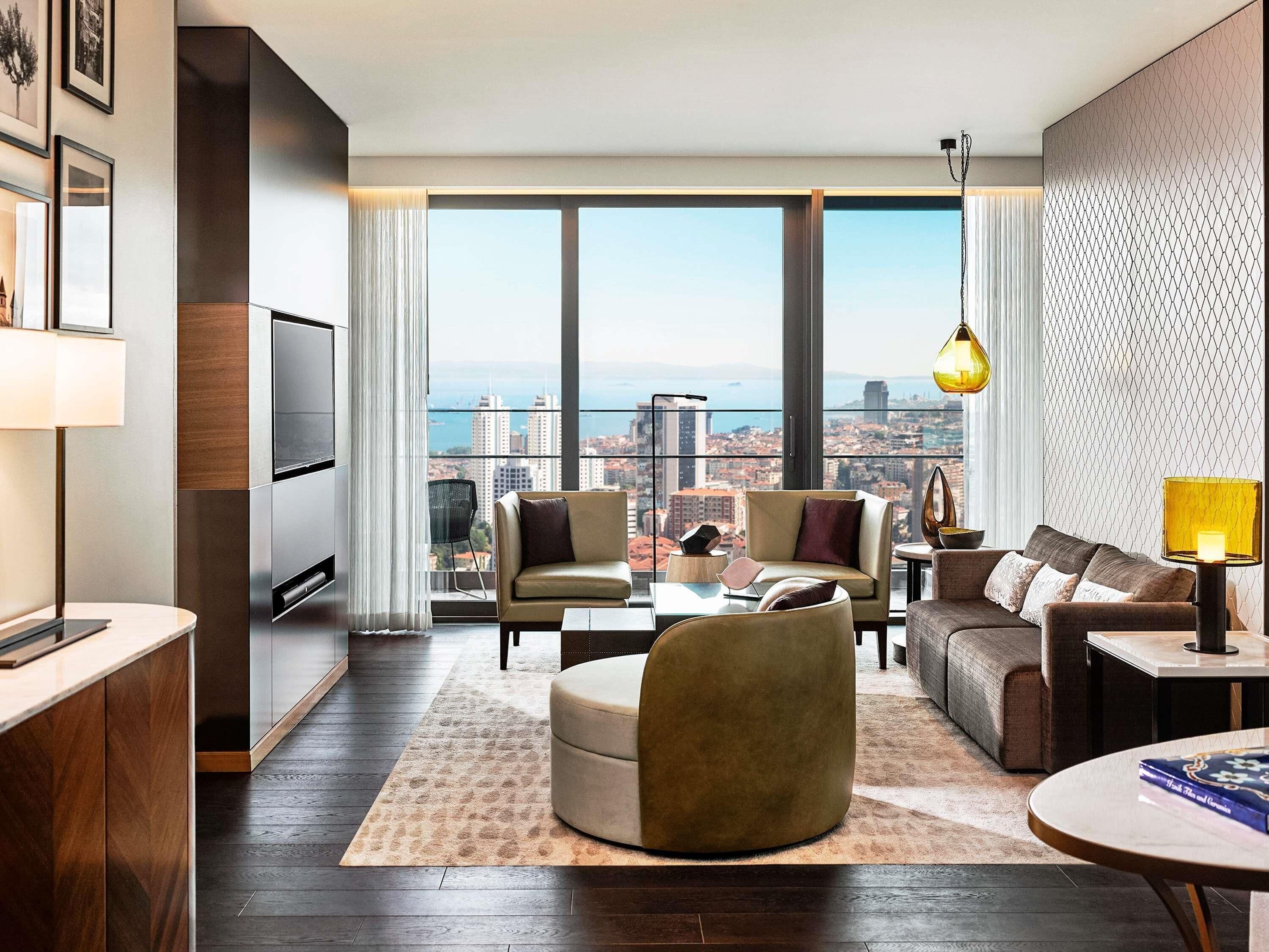 A modern living room with a city view, a sofa, a coffee table, and a TV.