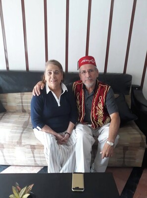 Two people sitting on a sofa with a smartphone on a table in front of them. - Sipahi (Istanbul)