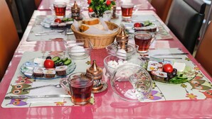 A table set with various food items, drinks, and utensils, suggesting a dining arrangement. - Sipahi (Istanbul)