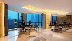 A modern hotel lobby with high ceilings, large windows, and a central bar area. - JW Marriott Hotel Chengdu (Chengdu)