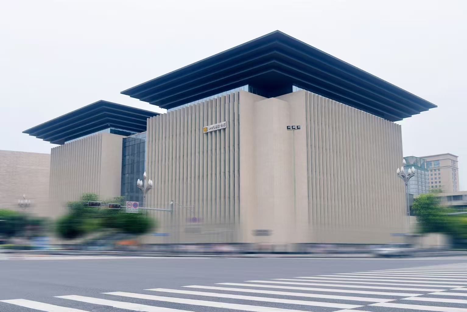 A modern building with a flat roof and vertical siding.