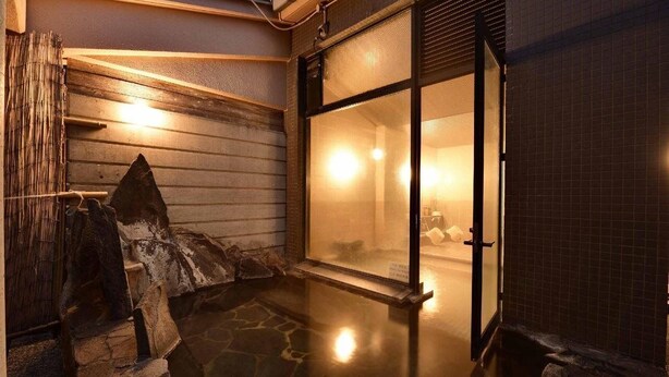 A traditional Japanese-style entrance with a stone pathway leading to a wooden door. - BENIKEA Yufuin Kinrinko Hotel Museum (Yufuin)