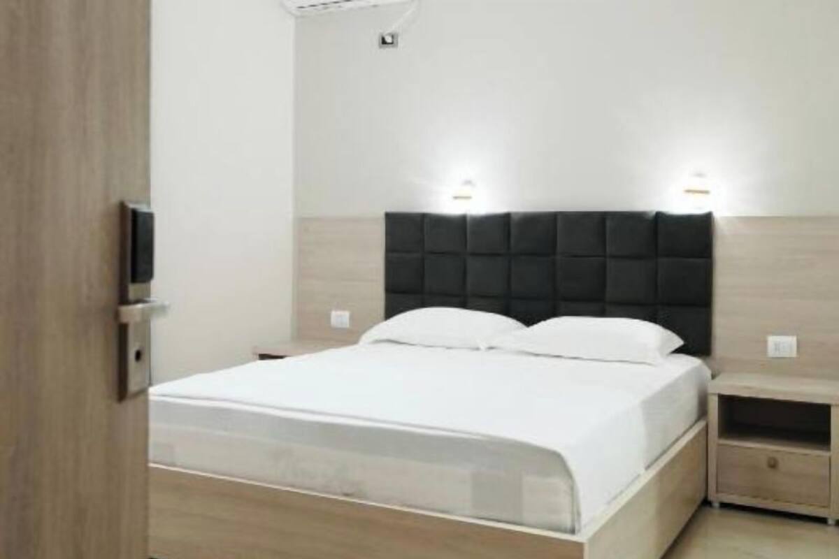 A modern bedroom with a bed, bedside tables, and a nightstand.