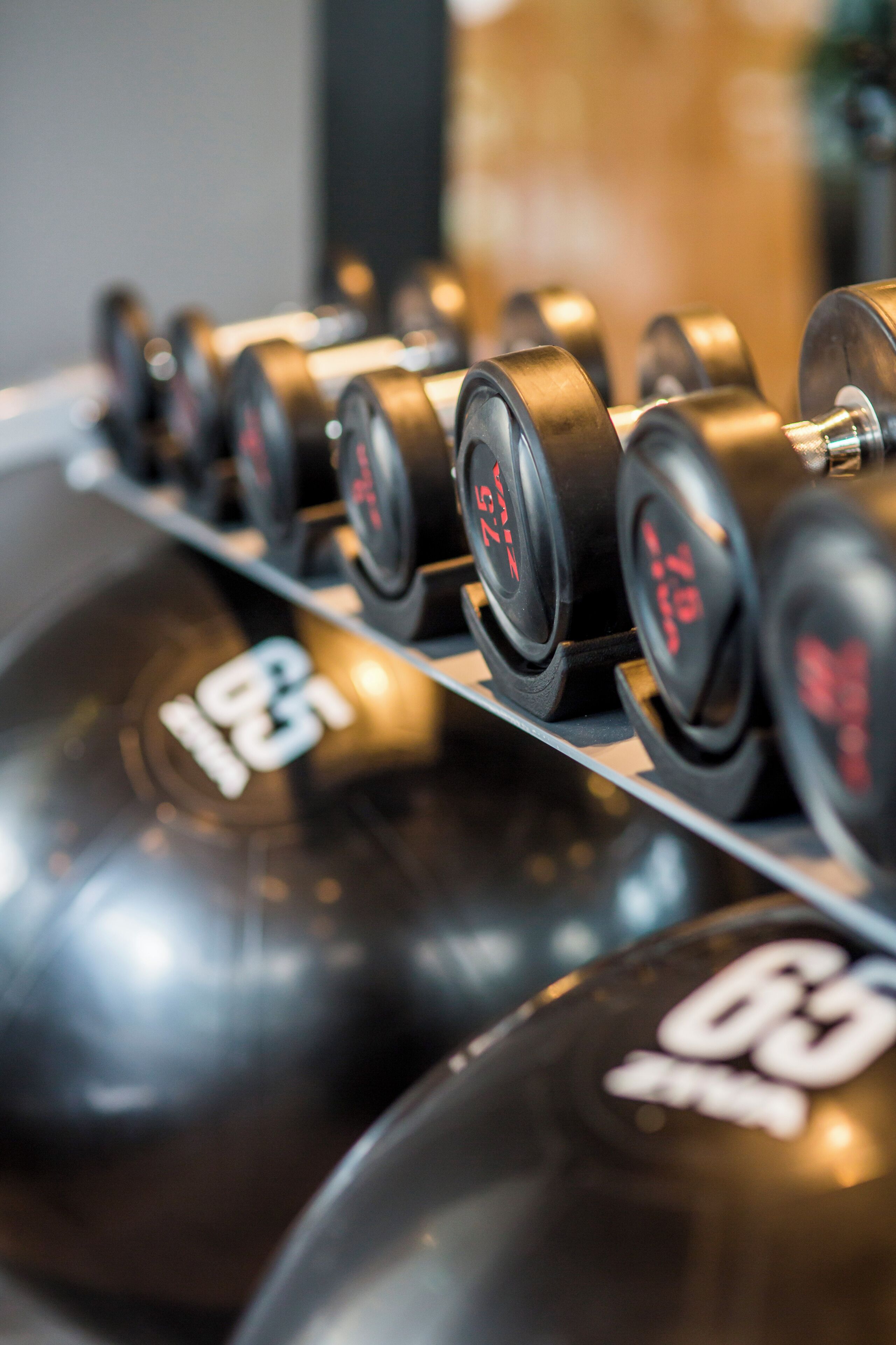 A row of weight plates with numbers indicating their weight.