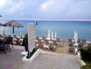 On the beach, sun loungers, beach umbrellas, beach bar