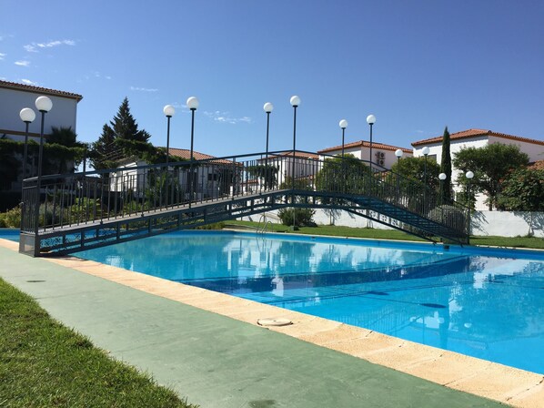 Outdoor pool, open noon to 9 PM, pool umbrellas