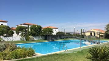 Outdoor pool, open noon to 9 PM, pool umbrellas