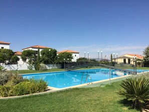 Outdoor pool, open noon to 9 PM, pool umbrellas