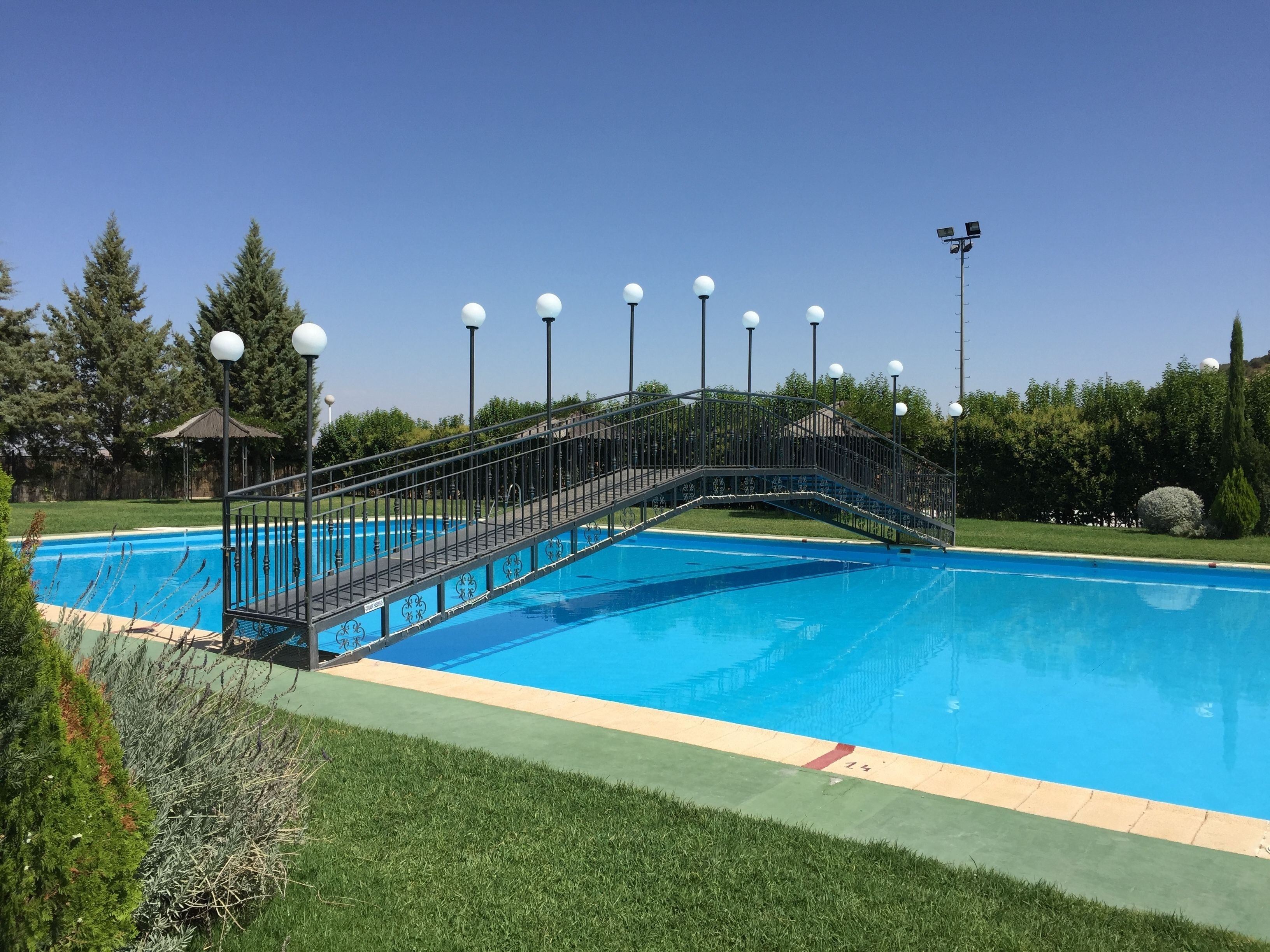 Outdoor pool, open noon to 9 PM, pool umbrellas