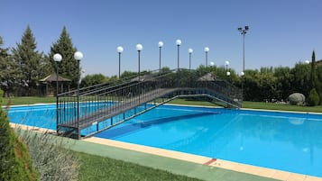 Outdoor pool, open noon to 9 PM, pool umbrellas