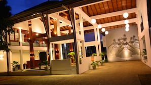A modern building with a spacious interior, a balcony, and a mural on the wall. - The Thinnai Hotel (Jaffna)