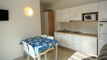 Apartment, 1 Bedroom | Private kitchenette | Full-size fridge, microwave, stovetop, cookware/dishes/utensils