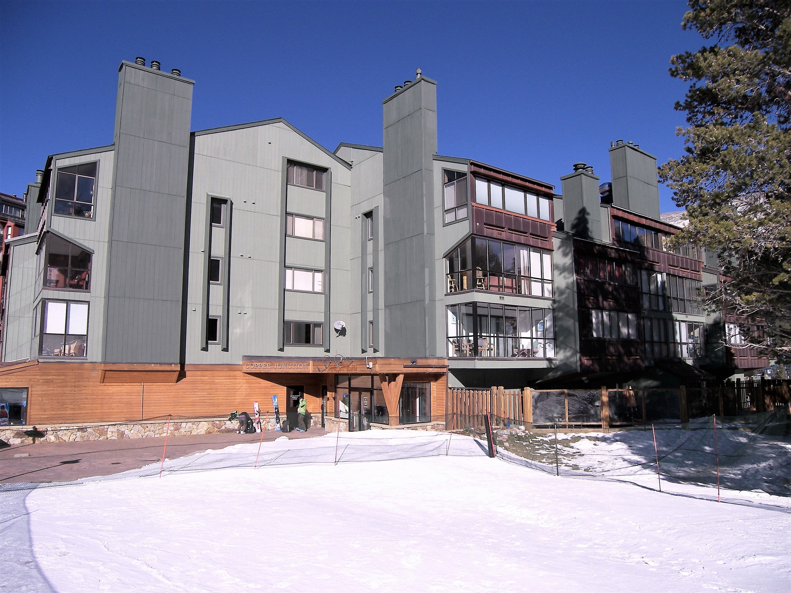A multi-story hotel with a modern architectural design, featuring balconies and large windows.