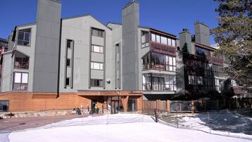 A multi-story hotel with a modern architectural design, featuring balconies and large windows.