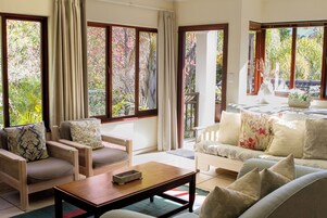 Deluxe Lavender Apartment | Living area | 32-inch LED TV with digital channels, TV