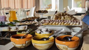 A breakfast buffet with various food items and beverages. - Posada y Spa Las Golondrinas (Villa La Arcadia)