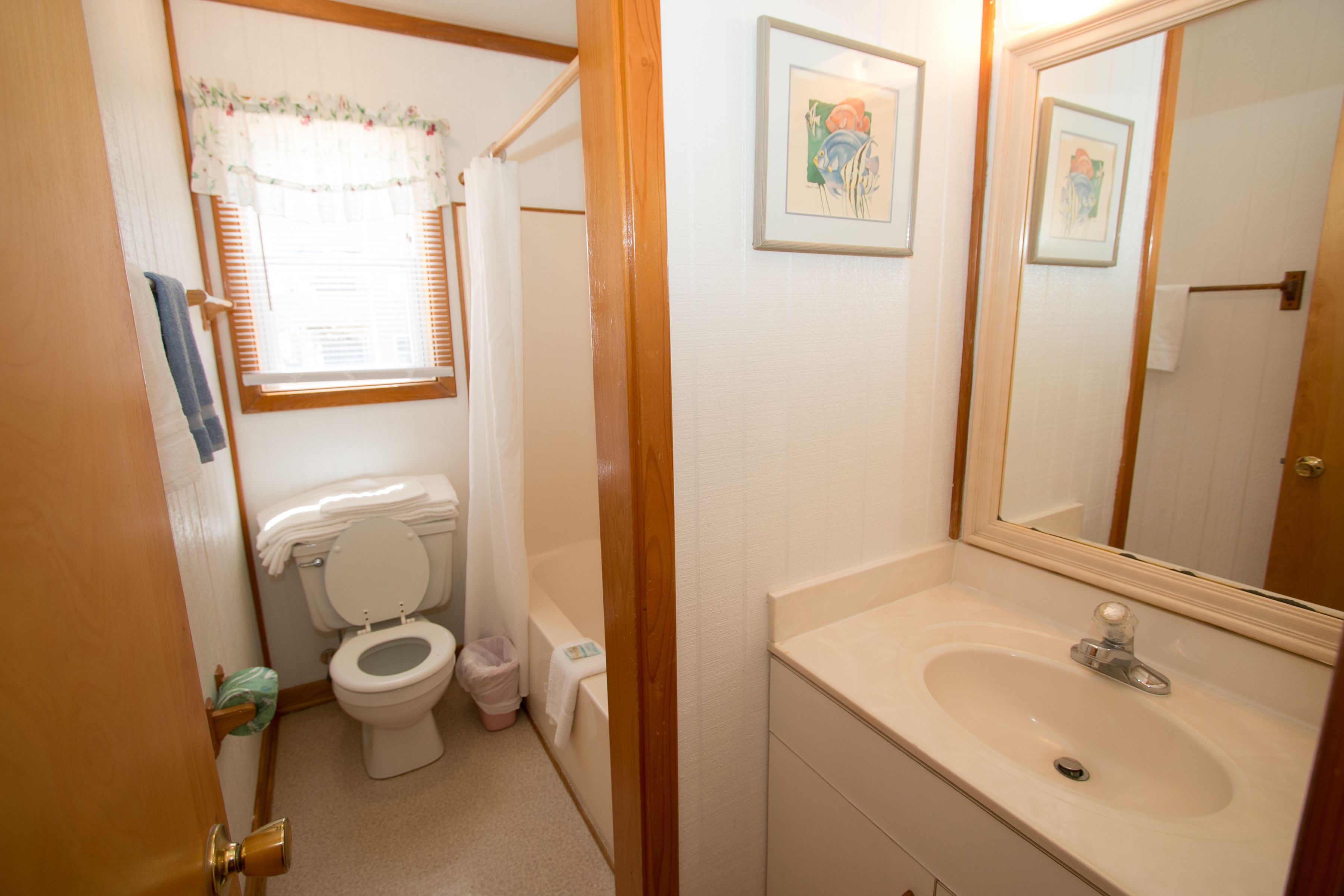 A bathroom with a toilet, sink, and shower.