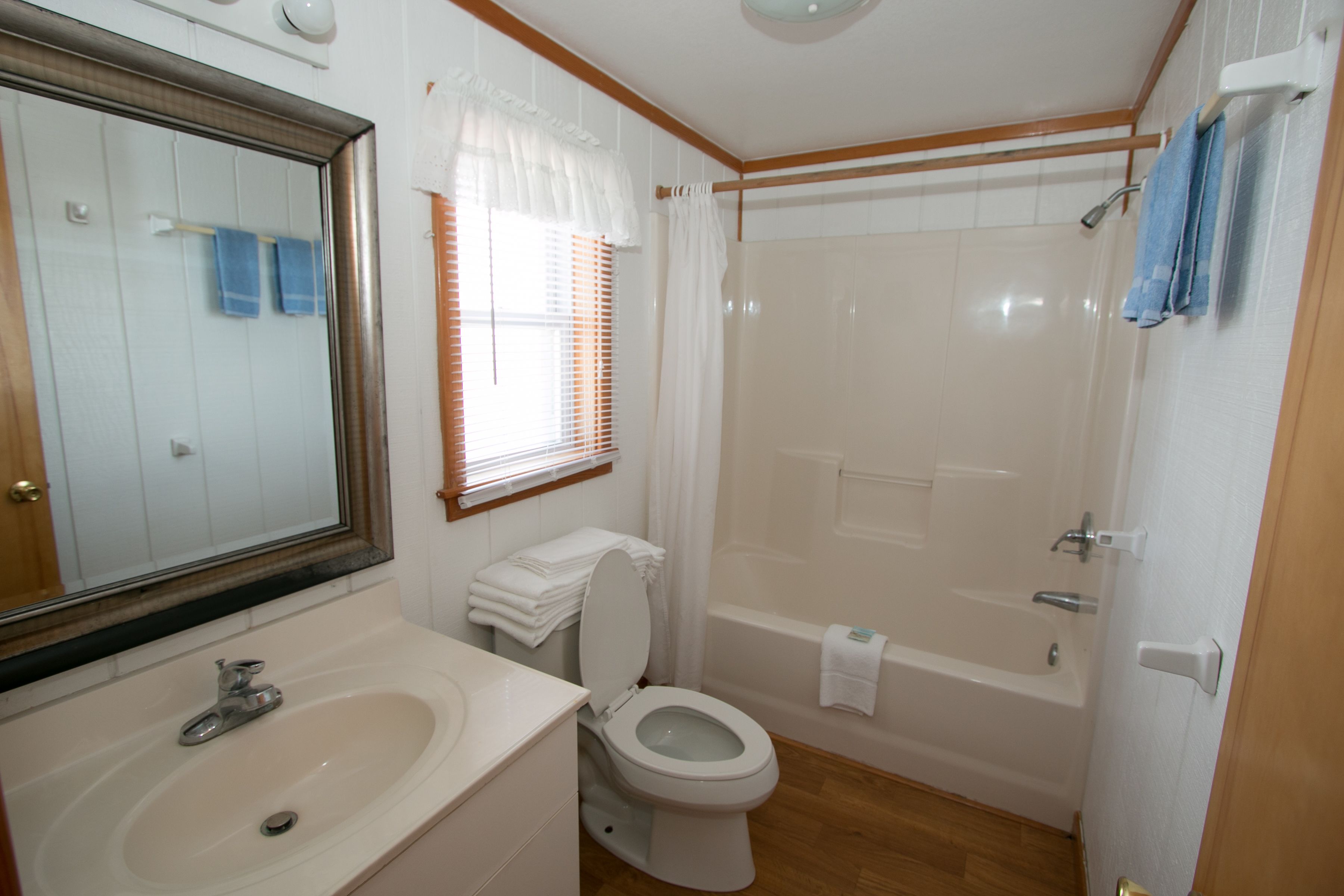 A bathroom with a sink, toilet, and bathtub.