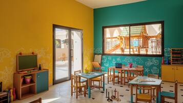 A classroom with wooden furniture, a chalkboard, and educational toys.
