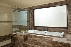 Bathtub, eco-friendly toiletries, hair dryer, towels