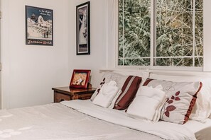 A bedroom with a bed, pillows, a nightstand, and two framed posters on the wall. - 01sl - Hot Tub - Pet Friendly - Bbq - Sleeps 8 3 Bedroom Home by RedAwning (Deming)