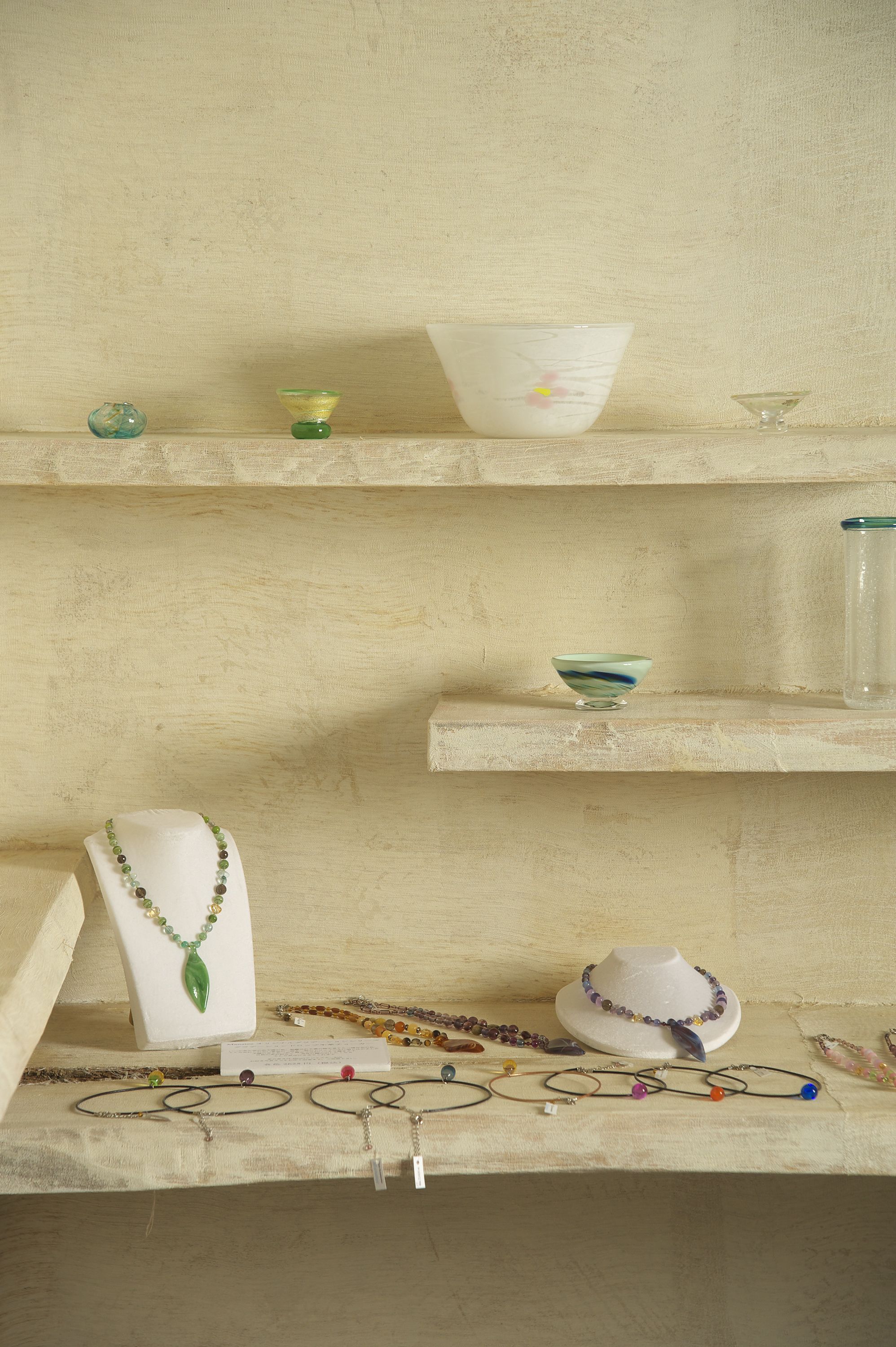A display of jewelry and accessories on shelves.
