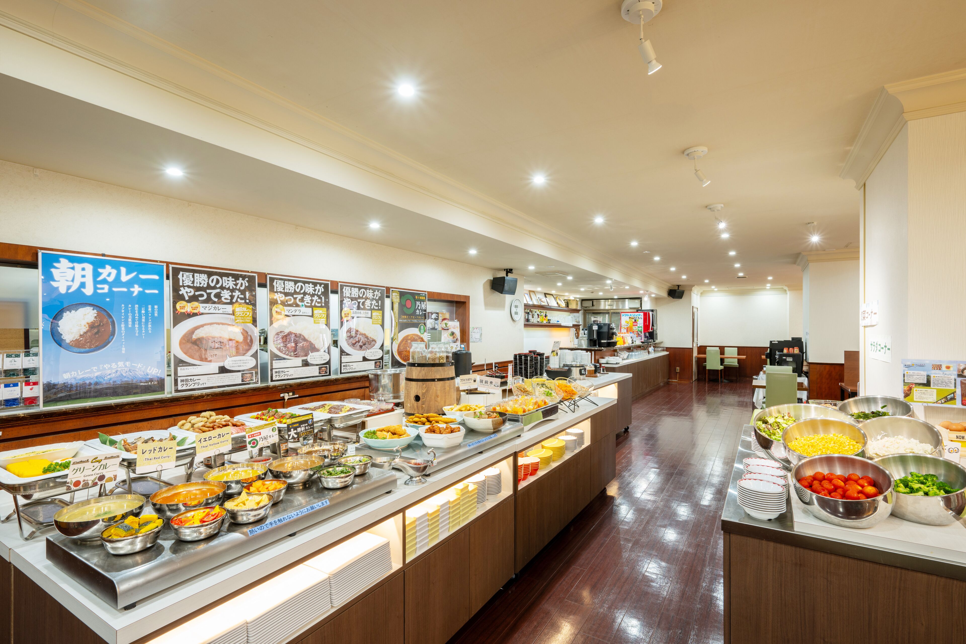 A buffet with various food options and a coffee station.