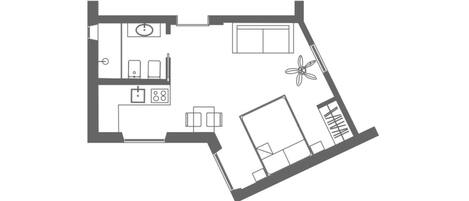 A floor plan of a hotel room with a bed, a desk, a chair, a small table, and a window.