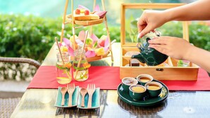 A table set with a drink, a tray with food, and a teapot. - Hoi An Central Boutique Hotel & Spa (Da Nang)