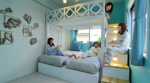 A room with a bunk bed, a reading area, and wall art. - Enoshima Guest House 134 - Hostel (Fujisawa)