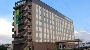 A multi-story hotel with a flat facade, multiple balconies, and a prominent entrance. - Hotel Route Inn Isesaki Inter (Isesaki)