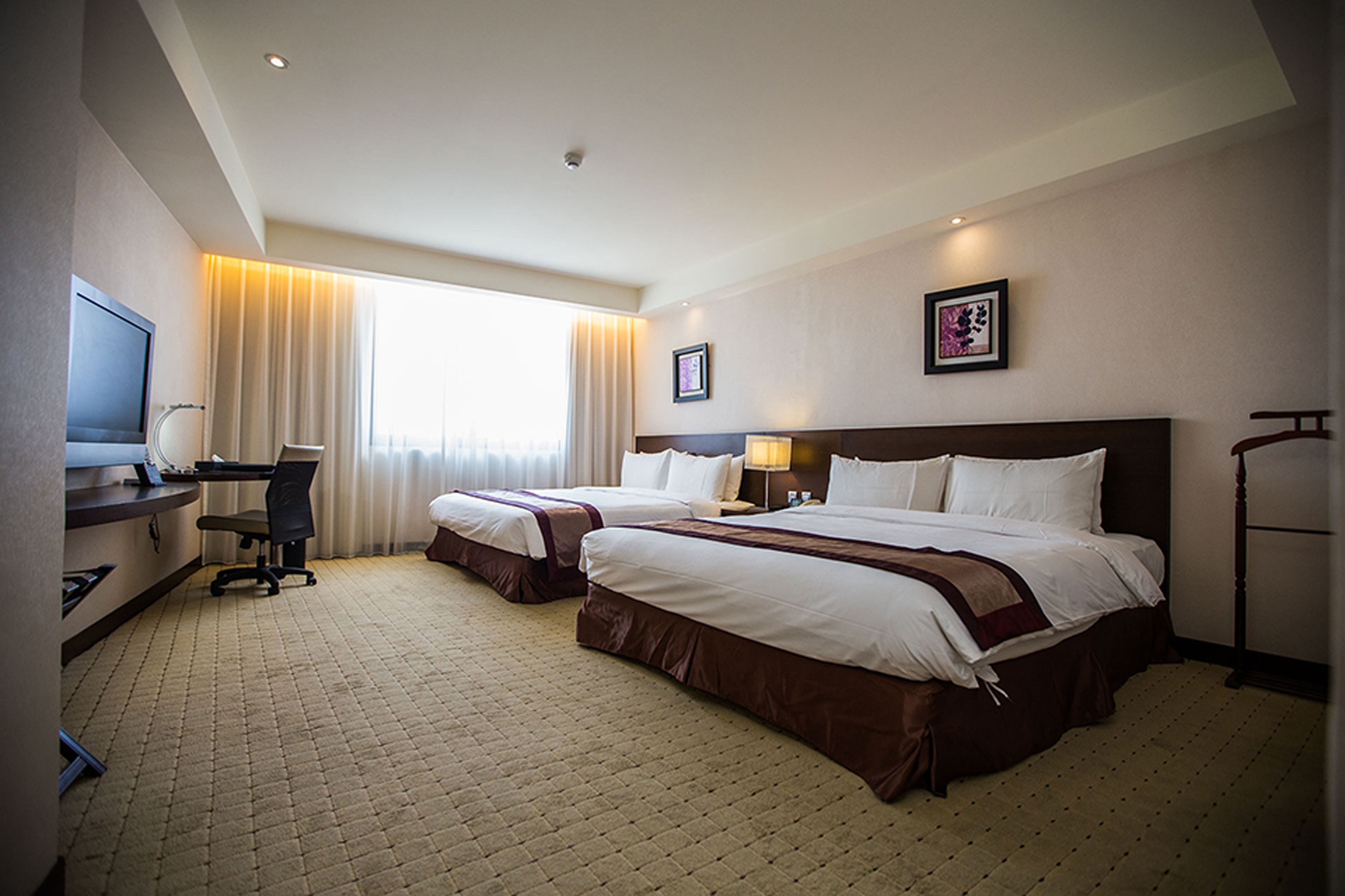 deluxe quadruple room, multiple beds | premium bedding, minibar, desk, blackout curtains