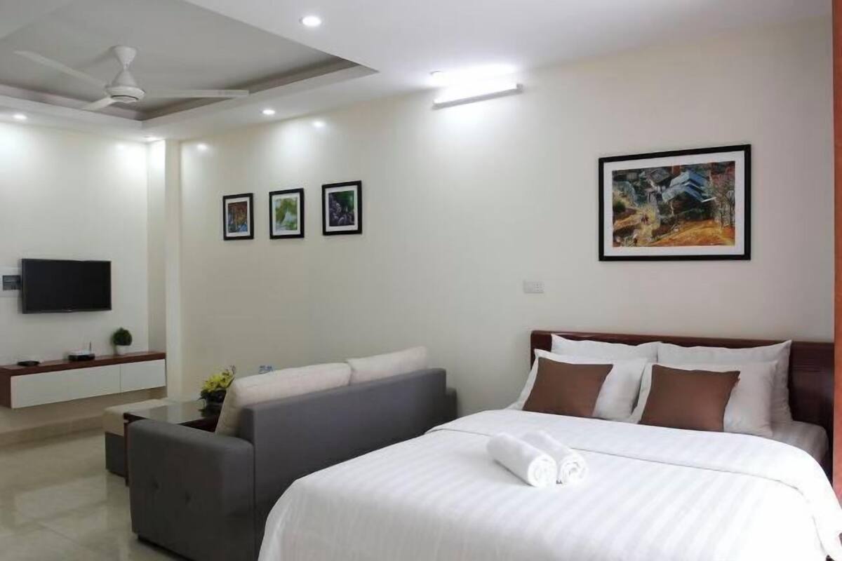 Premium bedding, desk, laptop workspace, blackout drapes