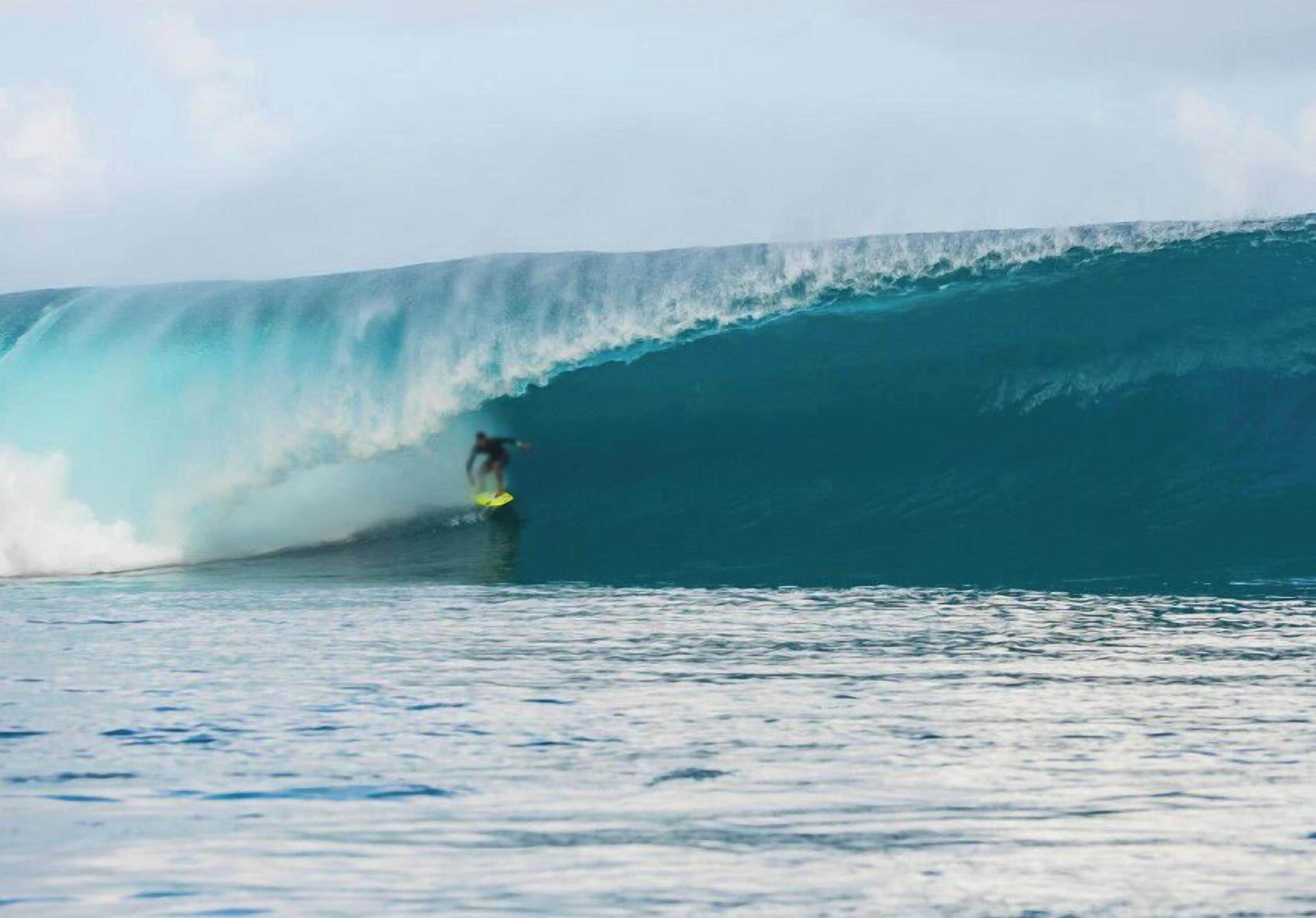 Un surfista cabalgando una ola grande en el océano.