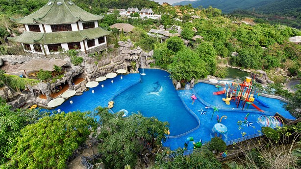 A traditional Chinese-style building with a large swimming pool and water park facilities. - Nui Than Tai Ebisu Onsen Resort (Da Nang)