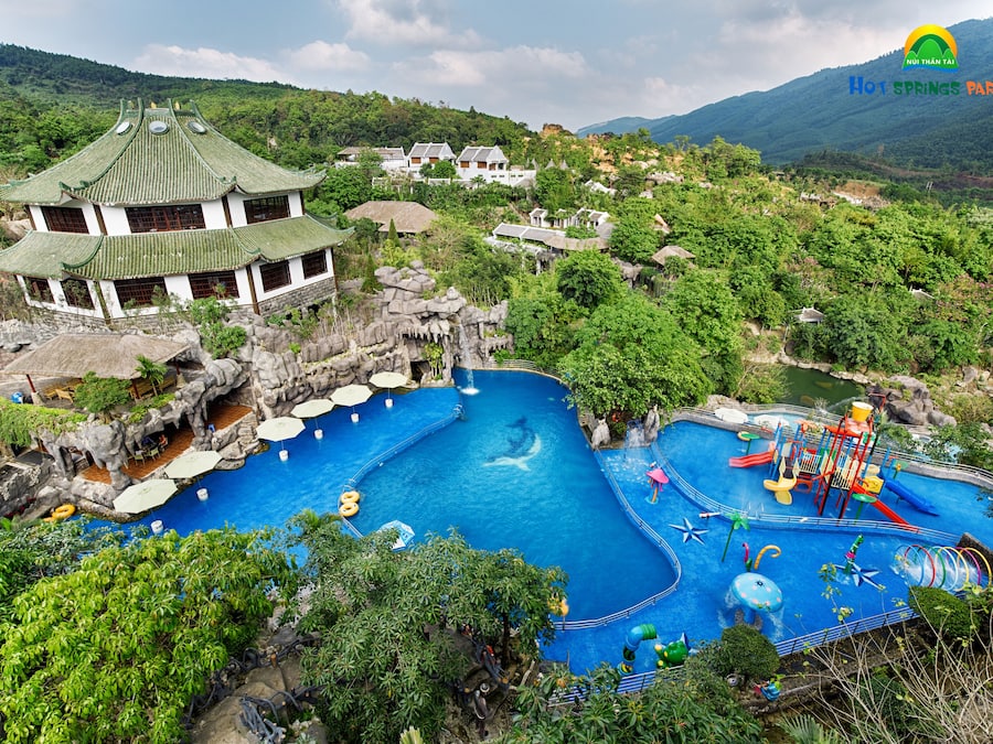A traditional Chinese-style building with a large swimming pool and water park facilities.