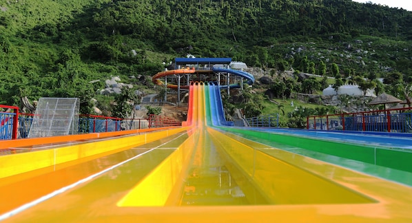 A water park with multiple water slides in various colors.