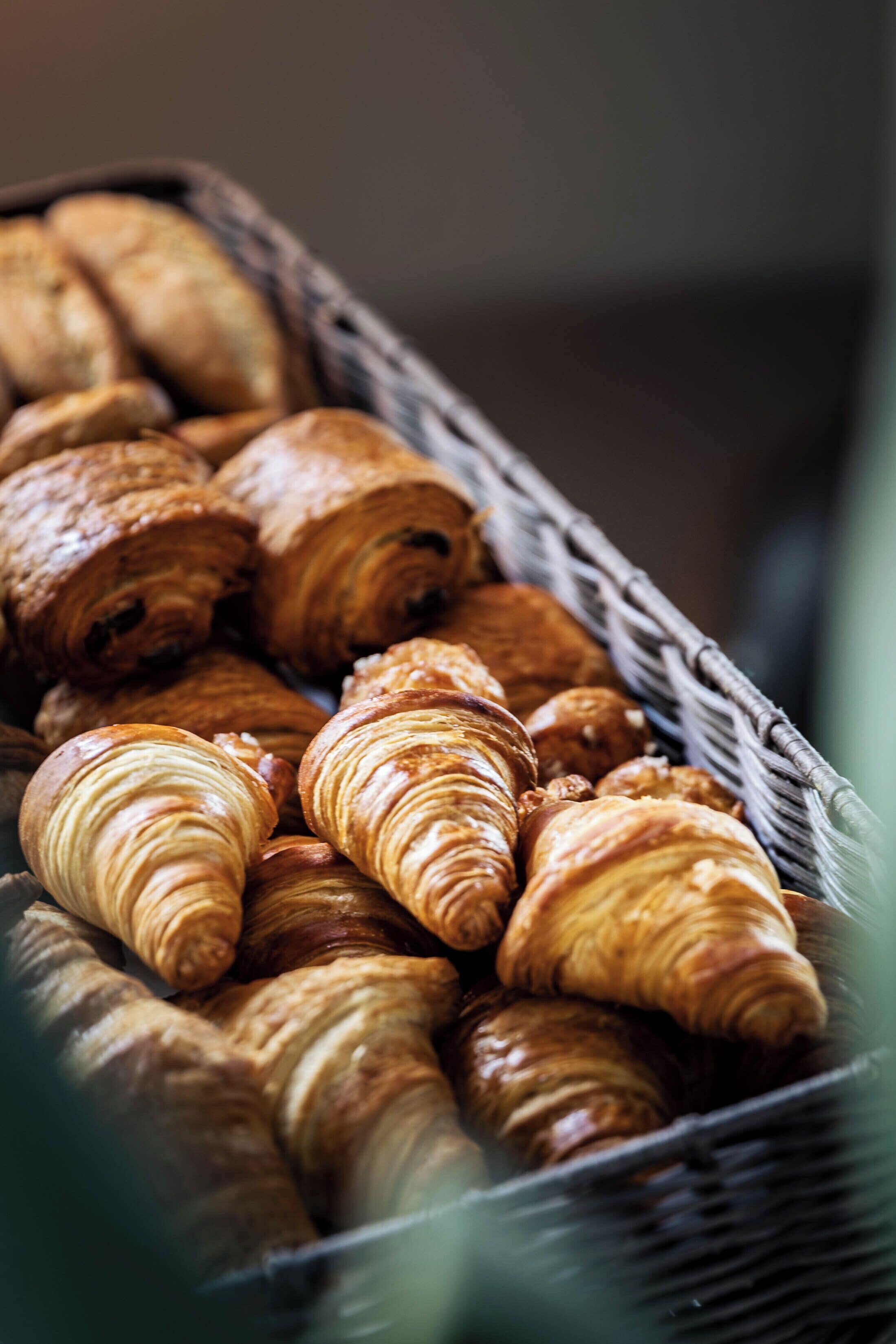 A basket filled with croissants.