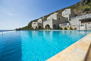 Seasonal outdoor pool, open 8 AM to 7 PM, pool umbrellas, pool loungers