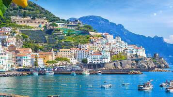 A coastal town with buildings on a hillside overlooking the sea.