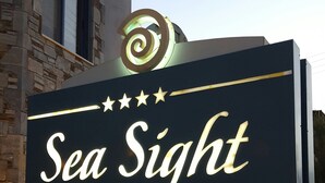 A sign for "Sea Sight Boutique Hotel - Apartments" with a decorative top and stars. - Sea Sight Hotel (Markopoulo Mesogaias)