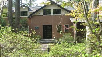 Set amidst lush surroundings, this charming two-story building offers a secluded retreat.