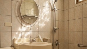 A bathroom with a toilet, sink, and bathtub. - Good Hotel (Taichung)