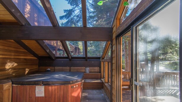 A wooden hot tub in a cabin with large windows and a deck. - Gamara 3 Bedroom Holiday Home By Tahoe Truckee (Truckee)