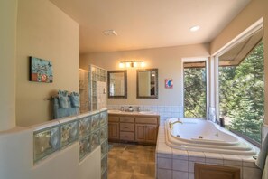 A spacious bathroom with a large window, a walk-in shower, a double vanity, and a freestanding bathtub. - Palisades 4 Bedroom Holiday Home By Tahoe Truckee (Truckee)