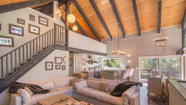 A spacious living area with a large sectional sofa, a wooden coffee table, and a kitchen in the background. - South Shore 5 Bedroom Holiday Home By Tahoe Truckee (Truckee)