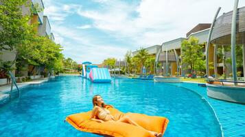 Relax by the pool with lounge chairs and umbrellas nearby.