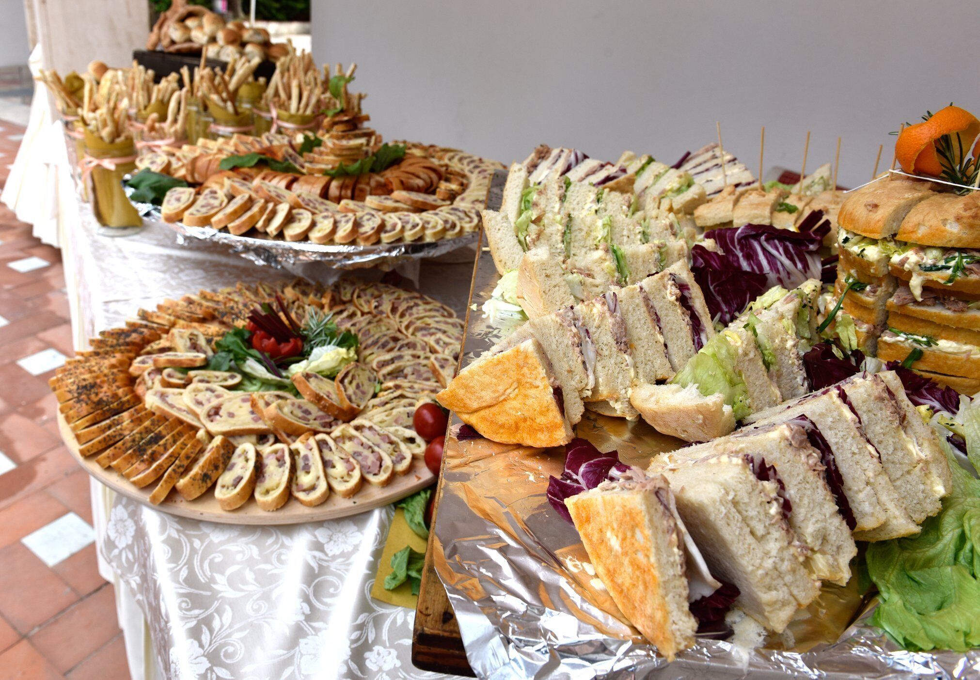 Una mesa de buffet con diversos sándwiches y aperitivos.