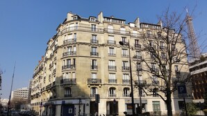 A multi-story building with a classic architectural style, featuring balconies and a central entrance. - Relais 12bis B&B (Paris)